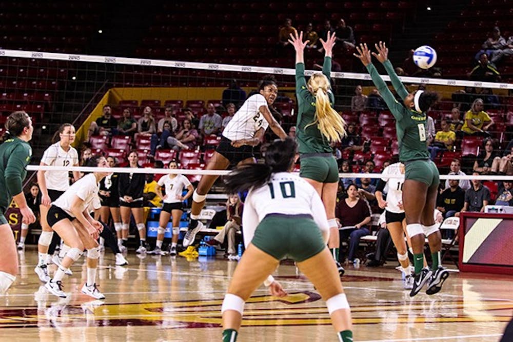 Junior middle blocker Mercedes Binns powers a shot in the fourth set of the ASU vs Oregon volleyball game at the Wells Fargo Arena on November 11th, 2014. The Sun Devils would win the fourth set 26-24 but lose in five 3-2 to the Ducks. (Photo by Daniel Kwon)