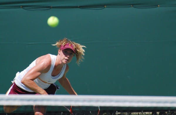 Senior Hannah James rips a shot over the net against UCLA on April 6. James was one of the ASU tennis players that had to adjust to a new role after the team was hit with injuries. (Photo by Murphy Bannerman)