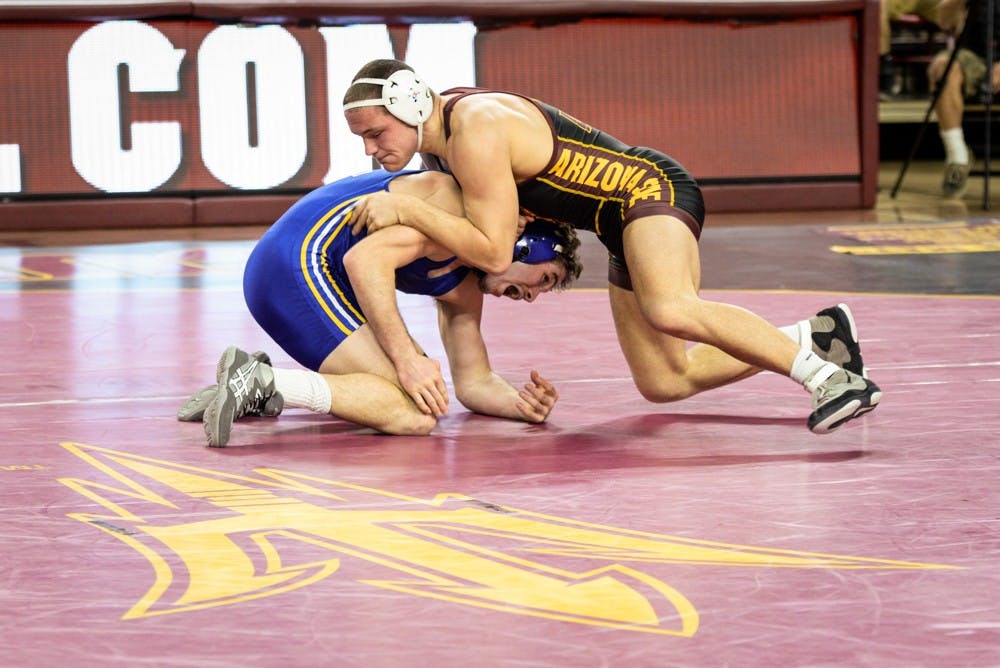 ASU wrestling's Blake Stauffer takes control early in his match against Roadrunner Sean Pollock on Saturday, Jan. 18, 2015, at Wells Fargo Arena in Tempe. The Sun Devils went on to win against the Roadrunners 28-6.