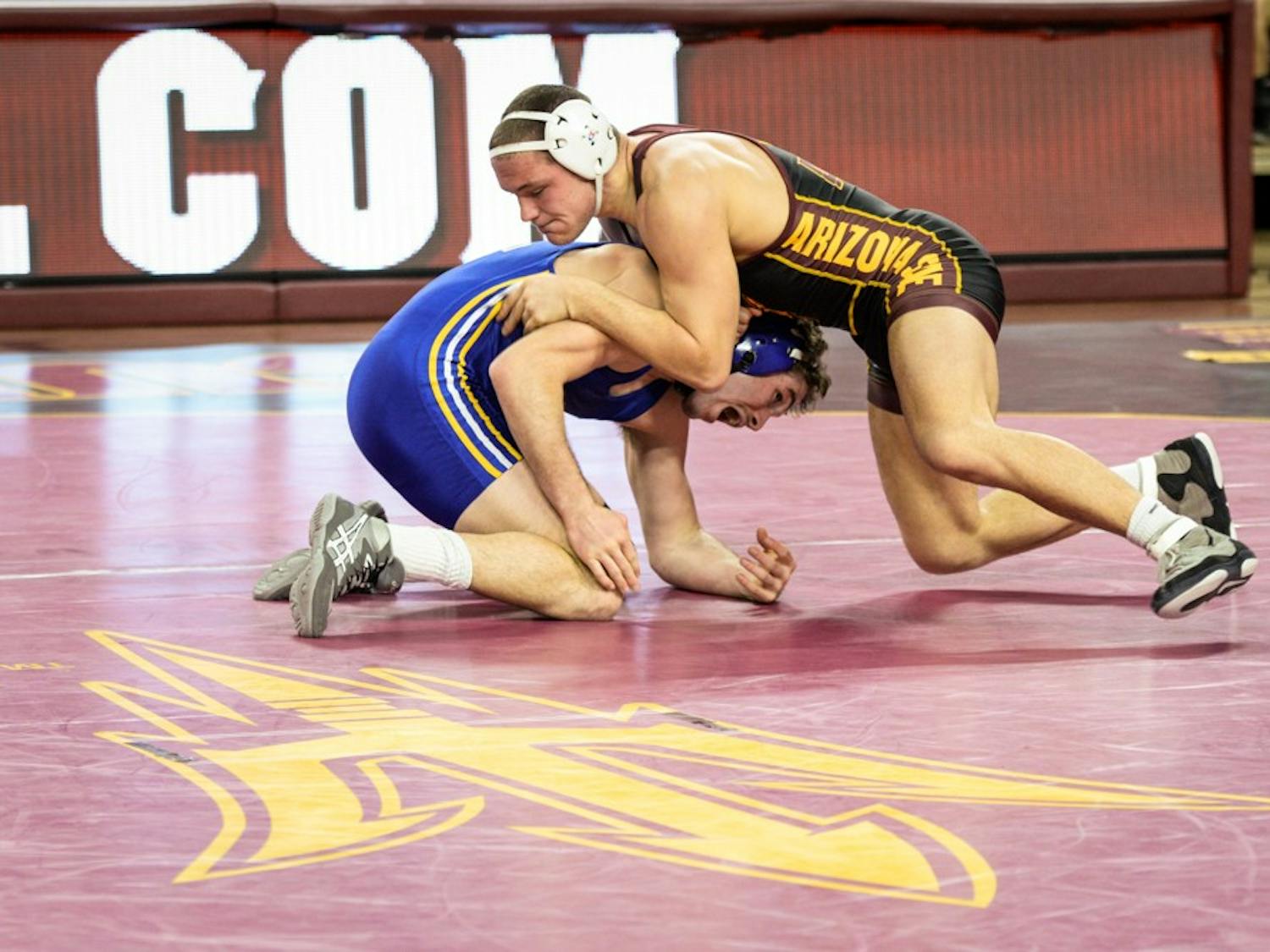 ASU wrestling's Blake Stauffer takes control early in his match against Roadrunner Sean Pollock on Saturday, Jan. 18, 2015, at Wells Fargo Arena in Tempe. The Sun Devils went on to win against the Roadrunners 28-6.