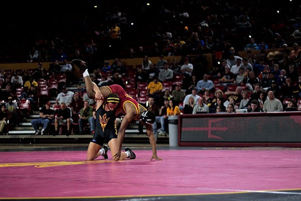 In a match against Utah Valley University on Saturday, Jan. 18, ASU's Joel Smith grapples with his opponent to gain the upper hand. (Photo by Mario Mendez)
