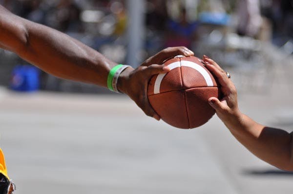 REACHING OUT: An ASU football player makes a connection with fan during the teams pep rally in front of the MU on Thursday. (Photo by Aaron Lavinsky)
