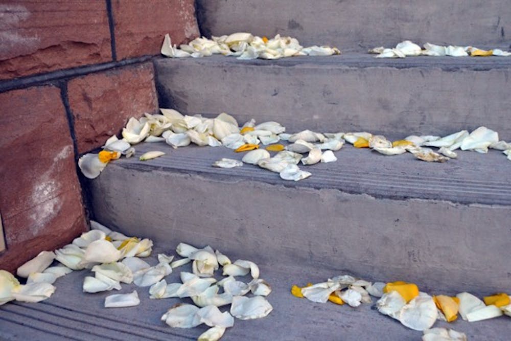 Rose petals from a celebration are strewn across the steps and walkway of Old Main on the Tempe campus on Sunday. (Photo by Mackenzie McCreary)