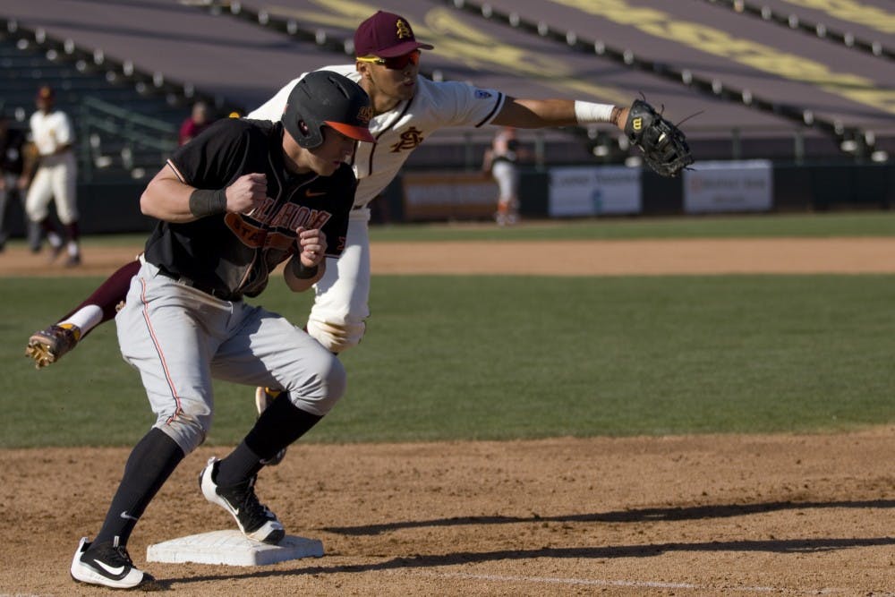 ASU freshman first baseman Lyle Lin (27) dives after a ball during a baseball game versus the Oklahoma State Cowboys at Phoenix Municipal Stadium in Phoenix on Tuesday, Feb. 21, 2017. ASU lost the game 18-4. (Josh Orcutt/State Press)