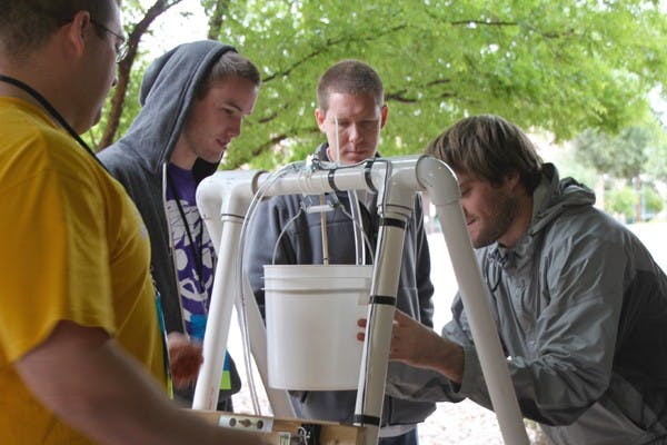 SOLAR SCRIMMAGE: ASU students Nathan Bakken, Trever Fleetham, Jeremy Ecton and Tyler Fleetham (left to right) won a competition to design, build, test and present the best overall solar-powered water pumping system at the Avnet Tech Games that took place at the University of Advancing Technologies on Saturday. (Photo by Rosie Gochnour)