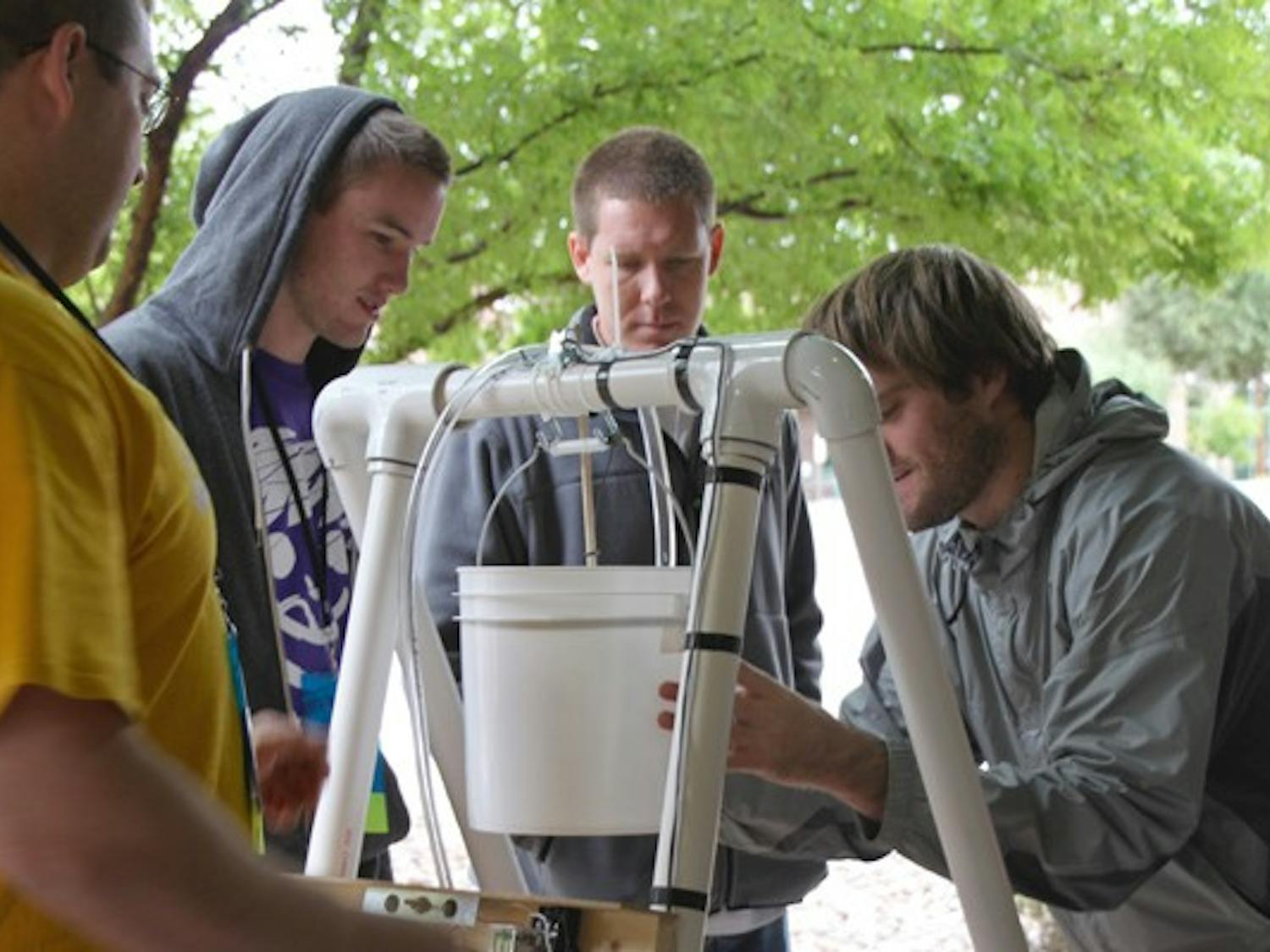 SOLAR SCRIMMAGE: ASU students Nathan Bakken, Trever Fleetham, Jeremy Ecton and Tyler Fleetham (left to right) won a competition to design, build, test and present the best overall solar-powered water pumping system at the Avnet Tech Games that took place at the University of Advancing Technologies on Saturday. (Photo by Rosie Gochnour)