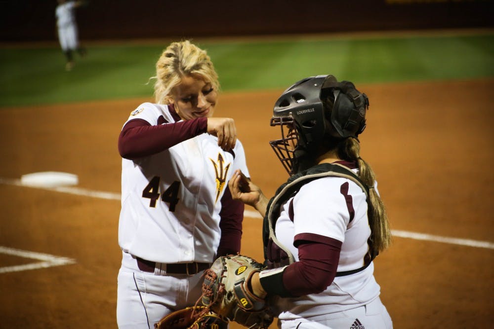 Junior Kelsey Kessler (#44) and Senior Katee Aguirre (#24) do a little handshake before a play at the home game versus Texas Tech on Thursday, March 24, 2016.