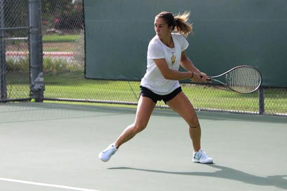 Sophomore Stephanie Vlad eyes the ball and starts her backhand hit in practice. (Photo by Evan Webeck)