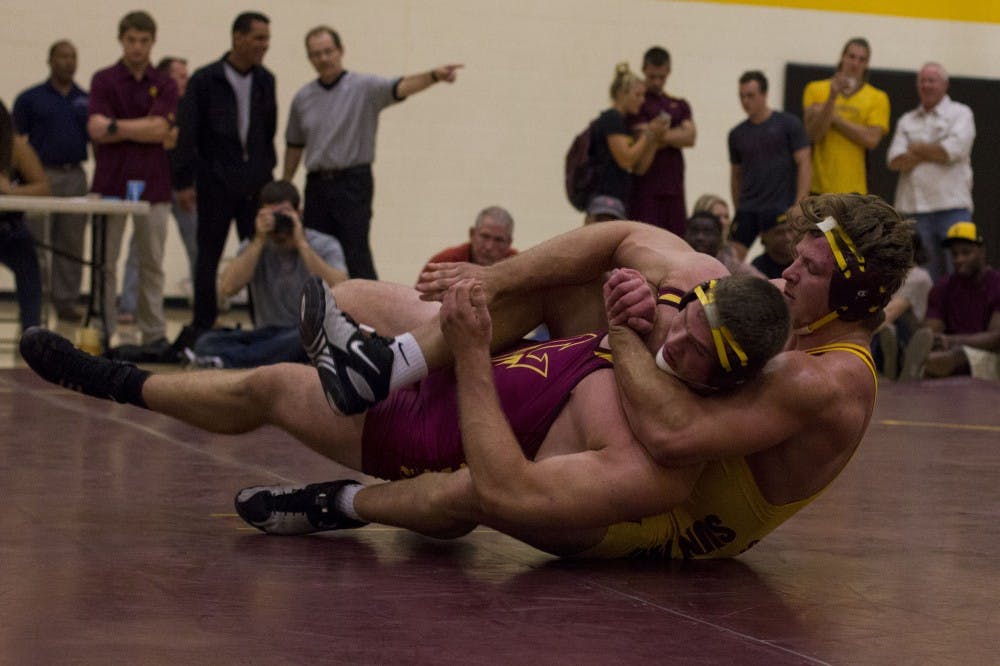 Red shirt junior Kyle Colling (right) wrestles with Daniel Gusev (left) during a practice event at the beginning of the season. 