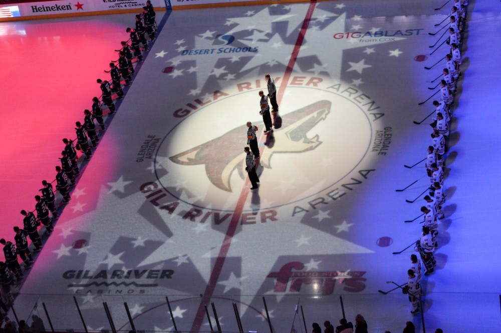 The ASU and UConn hockey teams prepare for the final game of the tournament during the National Anthem at the Desert Classic Tournament at Gila River Arena in Glendale, Arizona, on Sunday, January 10, 2016.