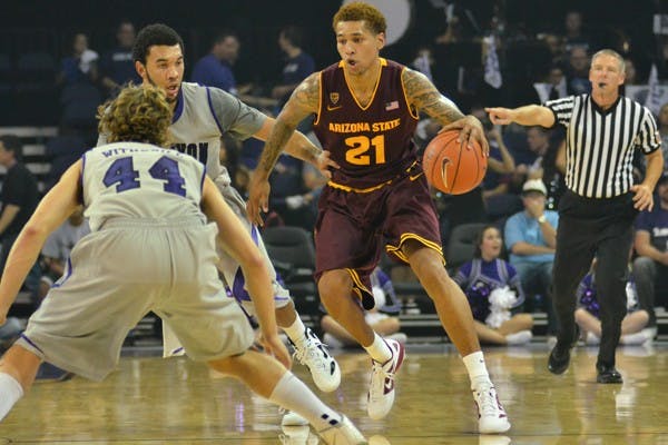 IN ENEMY TERRITORY: ASU sophomore guard Keala King (21) drives the ball against two Grand Canyon defenders during the Sun Devils’ 89-69 exhibition win over the Antelopes. The Sun Devils said they corrected some of their mistakes they were experiencing in practice in the ‘Lopes inaugural game at GCU Arena. (Photo by Aaron Lavinsky)
