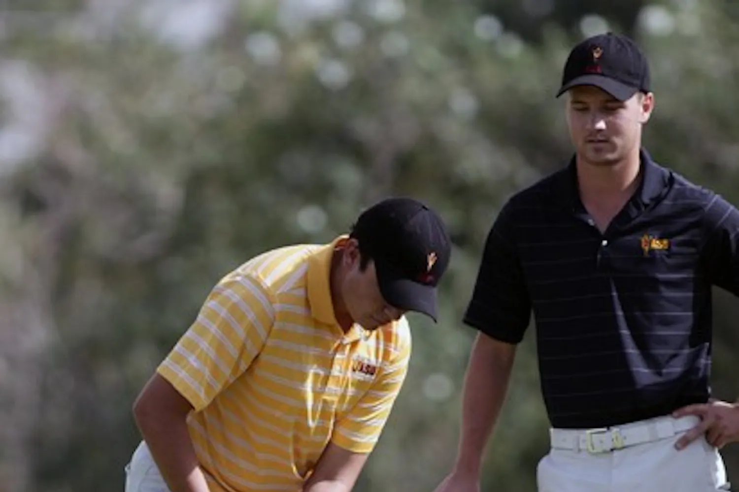 Freshman Cameron Palmer (left) practices putting with Mathias Schjoelberg (right) on Nov. 4, 2011. Palmer competed as an individual in the San Diego Intercollegiate Classic and was one of the few shining stars for the Sun Devils. (Photo by Beth Easterbrook)