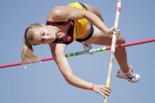 Junior pole vault specialist Kelli Gibson lifts her legs and twists her body over the pole during the ASU Invitational on March. 23. The ASU track and field team dominated their home meet taking 10 event titles. (Photo by Sean Logan)