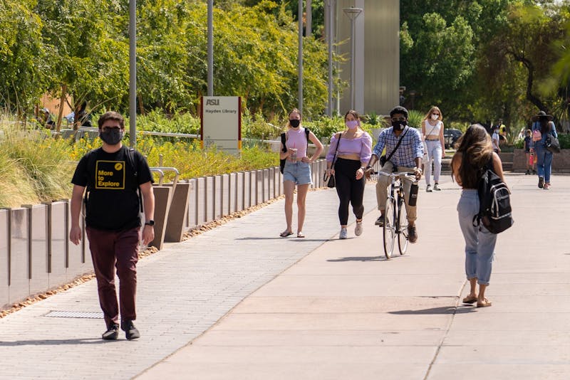 ASU students wearing masks walk and bike down Cady Mall on the Tempe campus on Wednesday, Sept. 16, 2020.