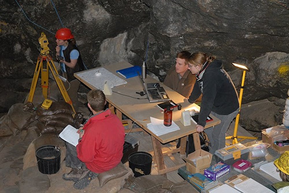 Student members of Professor Marean’s research team work in a Mossel Bay cave. (Photo Courtesy of Julie Russ/Photo by  SACP4)