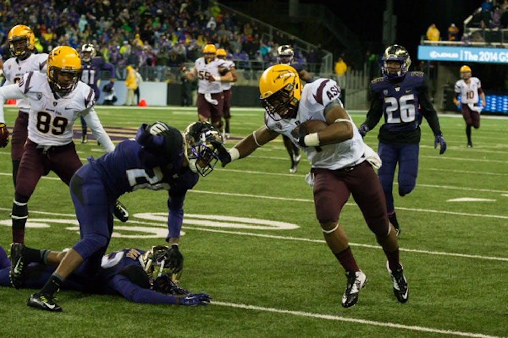 Redshirt senior running back Deantre Lewis stiff arms a defender during the game against Washington on Oct. 25. ASU defeated Washington 24-10. (Photo by Andrew Ybanez)