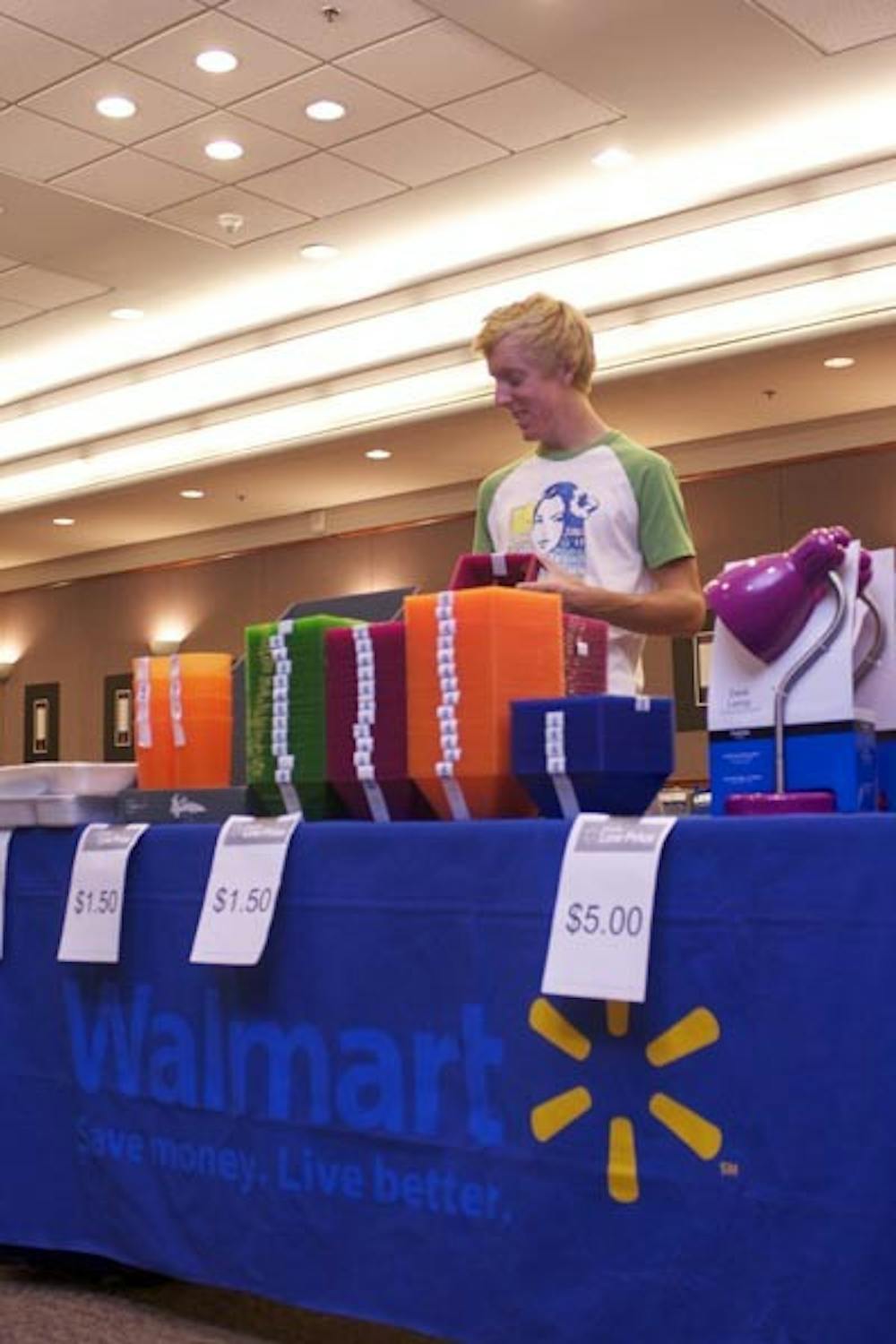 WAL TO WALL: Walmart set up a smaller version of its store in the basement of the Memorial Union during move-in week to allow students like Colton Tuttle to purchase any last minute supplies they may have forgotten for their dorm or apartment. (Photo by Scott Stuk)