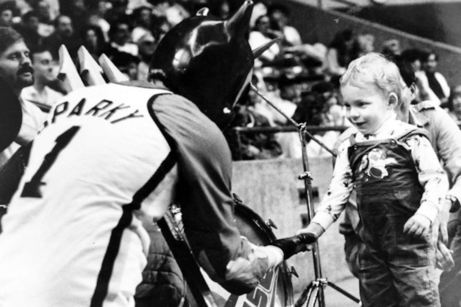LITTLE FAN: Sparky greets a young ASU admirer at a basketball game in 1988. (Photo by Susan Schuman)