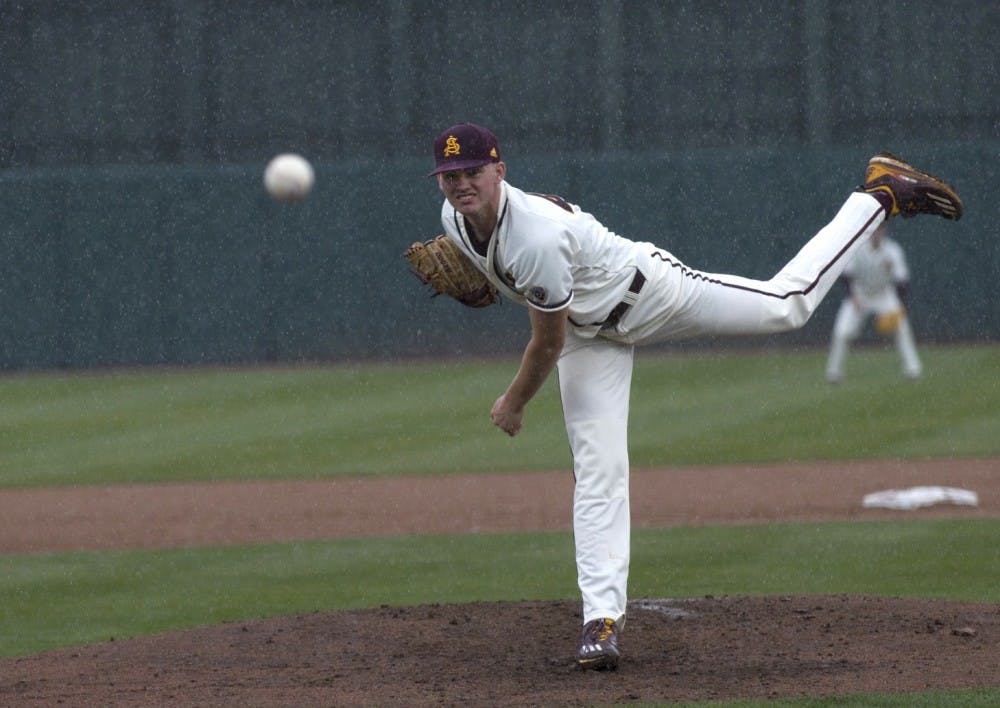 ASU freshman starting pitcher Spencer Van Scoyoc (44) pitches the ball to home plate in the pouring rain during a baseball game versus the Northwestern Wildcats in Phoenix Municipal Stadium in Phoenix, Arizona on Saturday, Feb. 18, 2017. (Josh Orcutt/State Press)
