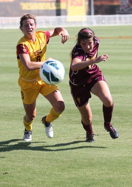 Freshman forward Cali Farquharson (right) chases after a lose ball against USC forward/midfielder Elizabeth Eddy during the Sun Devils’ 5-4 double overtime win over the Trojans. (Photo by Kyle Newman)