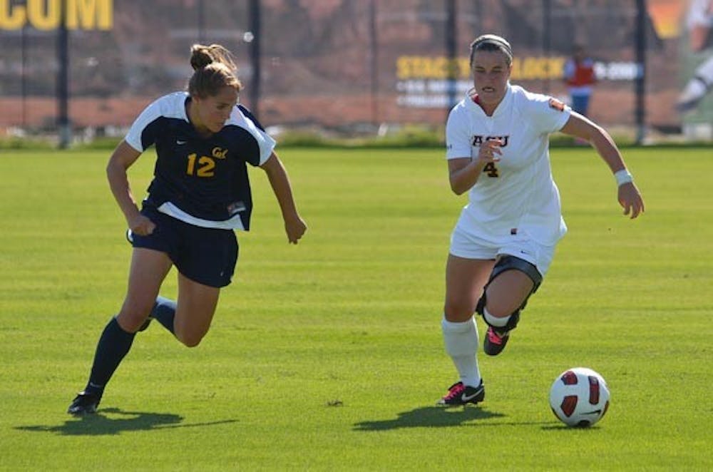 HOT PURSUIT: Senior midfielder/forward Jill Shoquist dribbles away from Cal sophomore forward Samantha Walker. The ASU women's soccer team is hoping to win at least two of their final four games to qualify for the NCAA tournament. (Photo by Aaron Lavinsky)