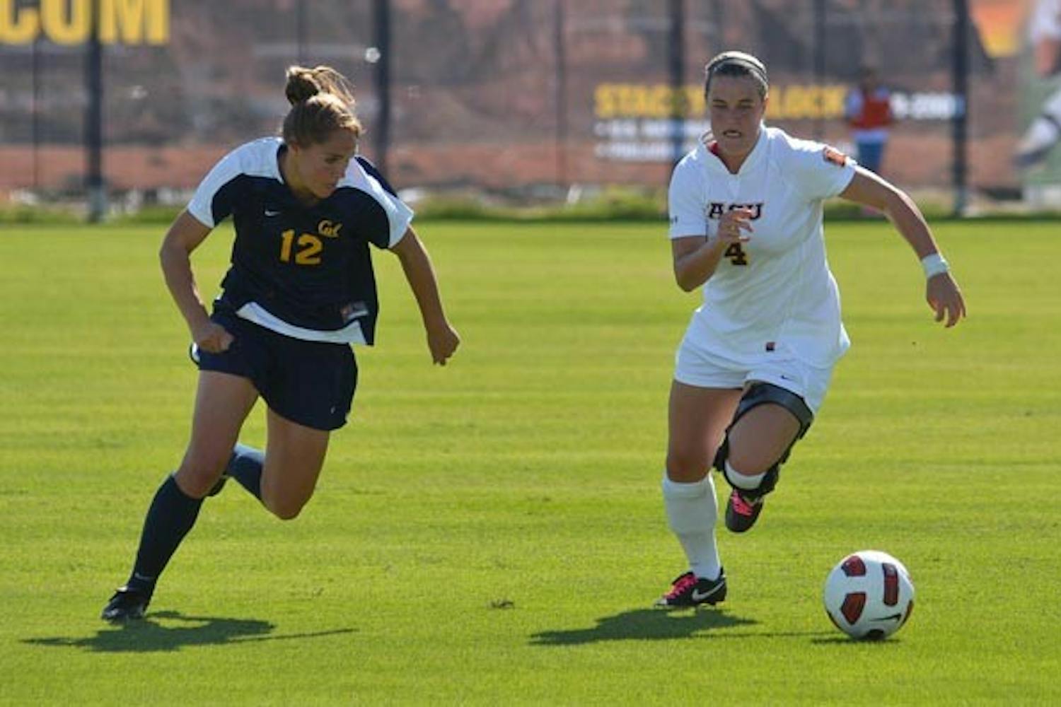 HOT PURSUIT: Senior midfielder/forward Jill Shoquist dribbles away from Cal sophomore forward Samantha Walker. The ASU women's soccer team is hoping to win at least two of their final four games to qualify for the NCAA tournament. (Photo by Aaron Lavinsky)