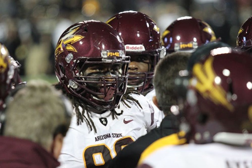 Redshirt junior defensive tackle Will Sutton (middle) listens in on a huddle, during the Sun Devils’ 51-17 win at Colorado on Oct. 11. (Photo by Kyle Newman)