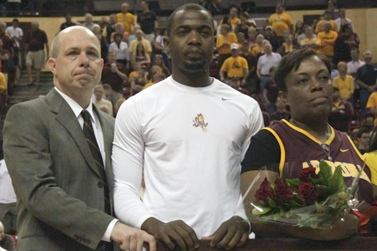 Bidding Farewell: ASU coach Herb Sendek (left) holds back the tears while standing next to Ty Abbott and his mother during senior introductions before the Sun Devils game against Oregon State Saturday. Abbott scored 22 points in his final regular season game. (Photo courtesy of Beth Easterbrook)