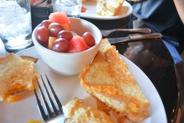 An egg and cheese sandwich accompanied with a fruit cup at Orange Table Tempe is one of many traditional breakfast selections available. (Photo by Aubrey Rumore)