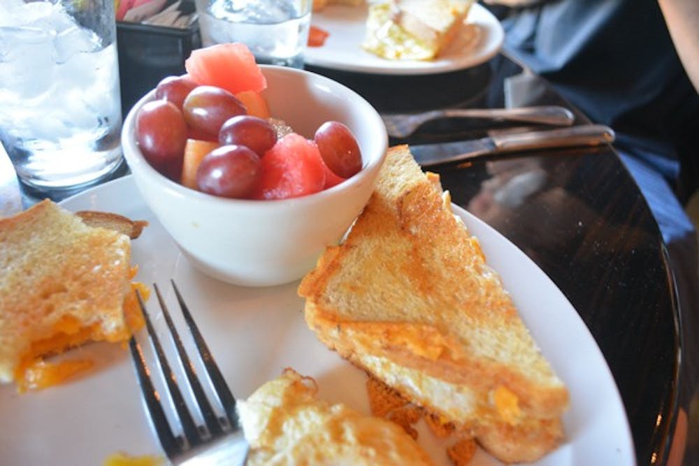 An egg and cheese sandwich accompanied with a fruit cup at Orange Table Tempe is one of many traditional breakfast selections available. (Photo by Aubrey Rumore)