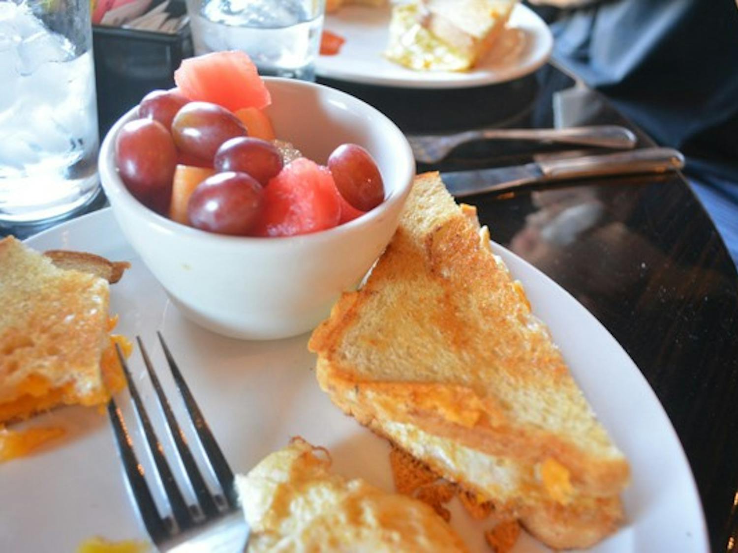 An egg and cheese sandwich accompanied with a fruit cup at Orange Table Tempe is one of many traditional breakfast selections available. (Photo by Aubrey Rumore)