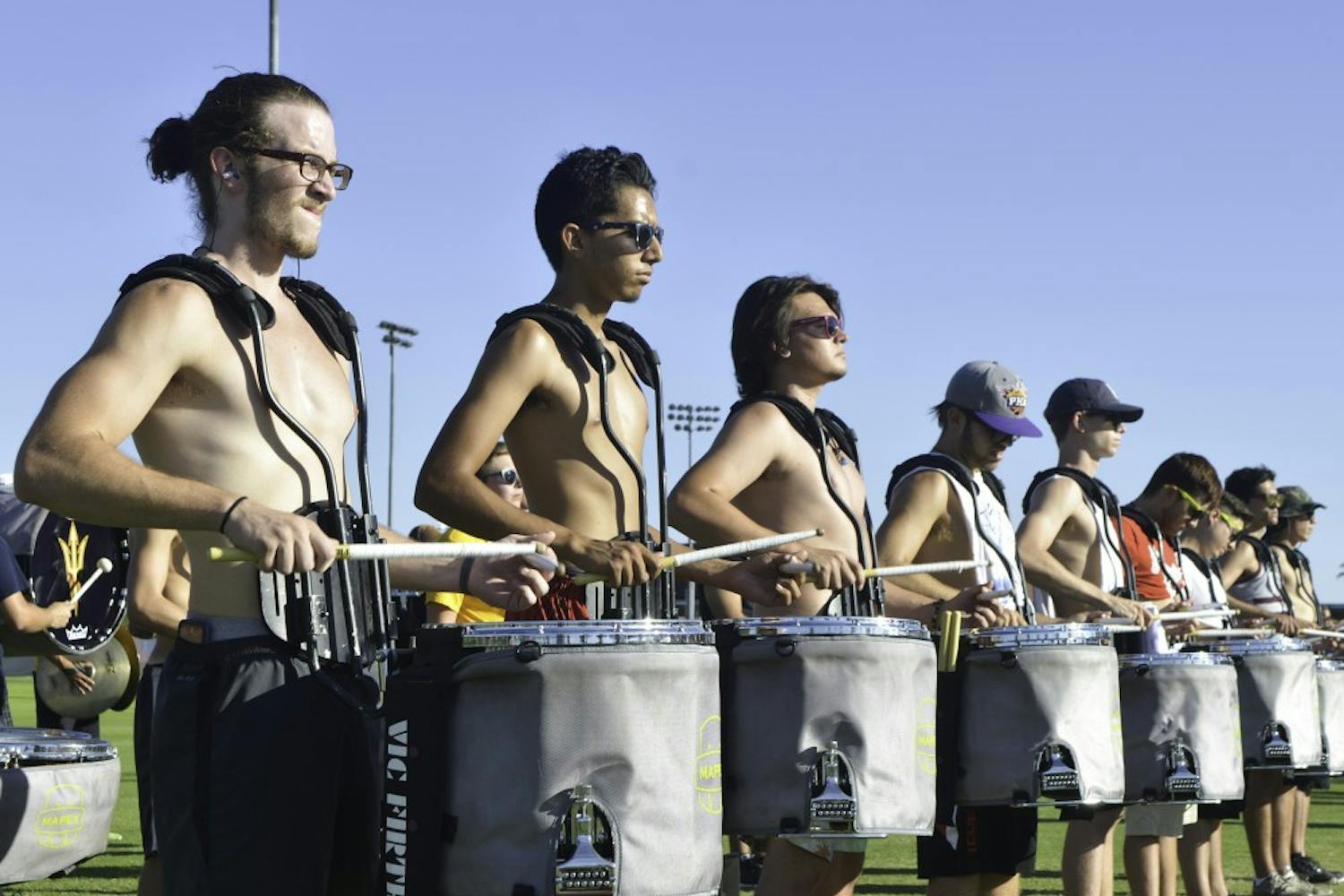 Sophomore Dustin Endicott, left, and freshman Sabeel Kaurram lead a drum line at the band's practice on Friday, Sept. 9, 2016.