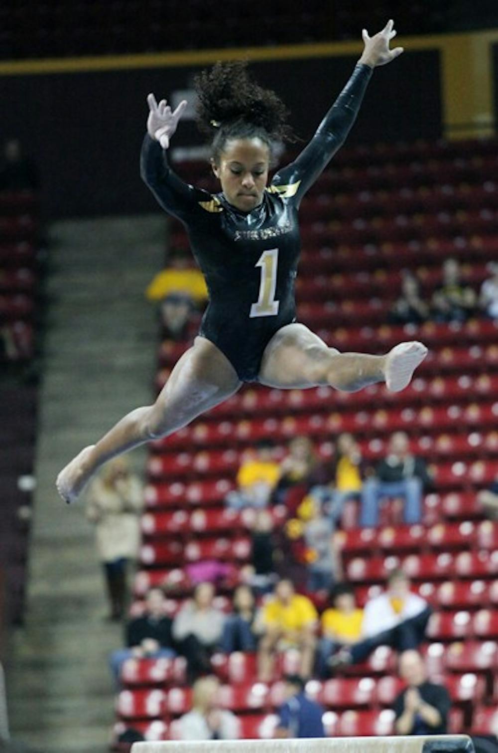 Beaté Jones performs a routine on the balance beam in a meet against UA on Jan. 27. The Gym Devils look to sweep the season series against the Wildcats. (Photo by Beth Easterbrook)