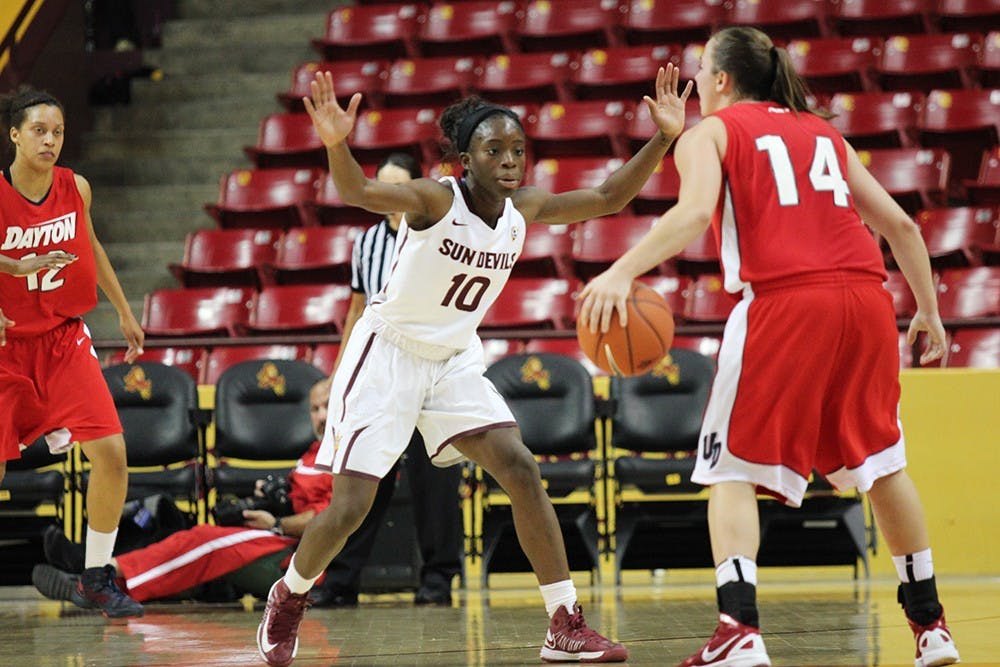 Junior Guard Promise Amukamara attempts to screen a player at a home game in Tempe. 