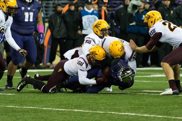 ASU defense takes down Washington wide receiver John Ross during the game against Washington on Oct. 25. ASU defeated Washington 24-10. (Photo by Andrew Ybanez)