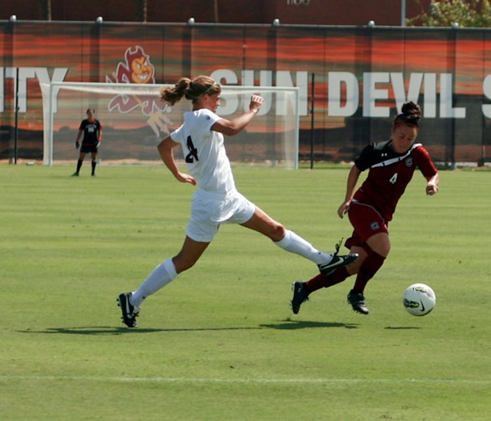 REACHING OUT: Sophomore defender Kaitlyn Pavlovich (left) attempts to steal the ball from South Carolina senior forward Kayla Grimsley during the Sun Devils’ 1-0 win over the Gamecocks on Aug. 28. The Sun Devils get a first look at new Pac-12 teams Utah and Colorado over the weekend. (Photo by Michaela Mader)
