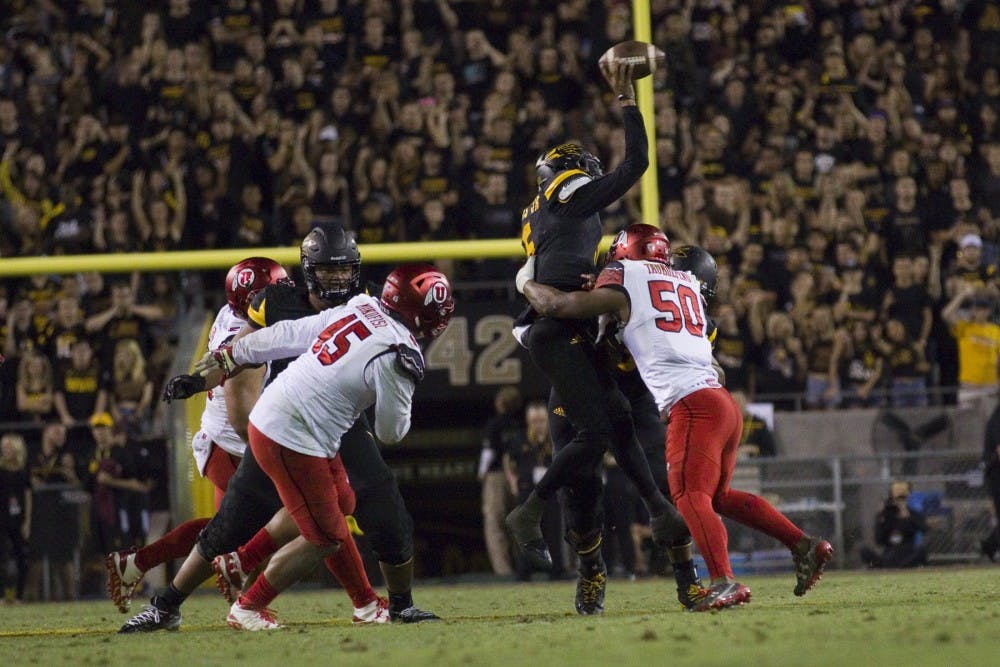 ASU redshirt sophomore quarterback Manny Wilkins (5) is hit while in mid-throw in the second half of a 49-26 loss to the Utah Utes in Sun Devil Stadium in Tempe, Arizona, on Thursday, Nov. 10, 2016.