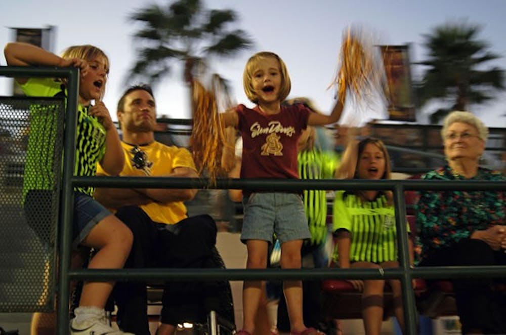 ASU fans cheer after the second winning goal from the Sun Devil women's soccer team on Nov. 2 in Tempe. The women's soccer team, which hosted their final game before playoffs, defeated rival University of Arizona 2-1. (Photo by Julie Vitkovskaya)