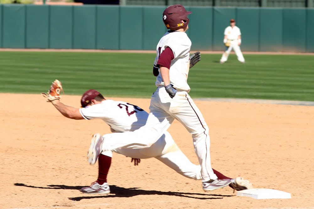 Junior first baseman David Greer (28) puts out freshman Jeremy McCuin (10) at the Maroon and Gold scrimmage on Saturday, Feb. 13, 2016. 