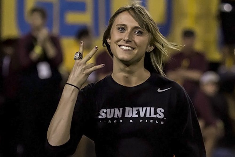 NCAA cross country champion Shelby Houlihan poses when recognized with at a home football game against Utah on Saturday, Nov. 1, 2014. Senior Shelby Houlihan won a Pac-12 title on Friday with a time of 19:59 in the 6,000 meter circuit in Oakland, California, and finished first in the 1,500-meter race at nationals last summer 4:18.10.