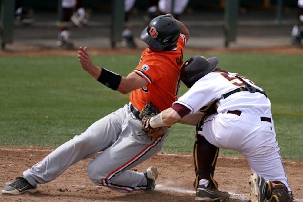 Max Rossiter tags a runner out at home plate in a game against Oregon State on April 7. Rossiter hit 3-for-4 in the Sun Devils’ 15–6 loss to New Mexico on Monday night. (Photo by Sam Rosenbaum)