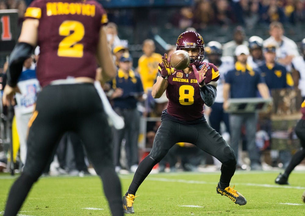 Senior wide receiver D.J. Foster (8) catches a screen pass from redshirt senior quarterback Mike Bercovici (2) against West Virginia during the Motel 6 Cactus Bowl on Saturday, Jan. 2, 2016, at Chase Field in Phoenix.