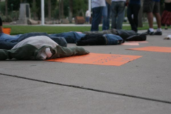 HEADLESS BODIES: At the Arizona State Capitol Saturday afternoon, people dressed as zombies and headless dolls were lying on the ground to mock Gov. Jan Brewer's comments about the headless bodies at the US-Mexico border. (Photo by Anthony Sandoval)