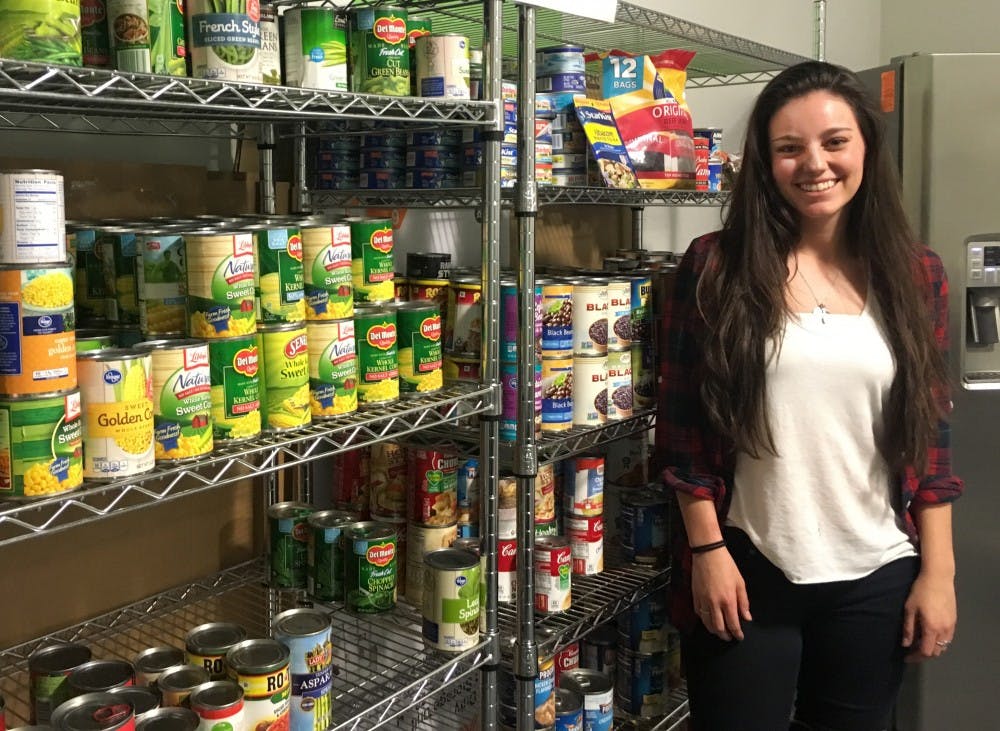 Becky Bender, vice president of Student Anti-Hunger Coalition, stands in front of the goods available at Pitchfork Pantry at ASU's downtown campus on Sunday, Feb. 5, 2017.