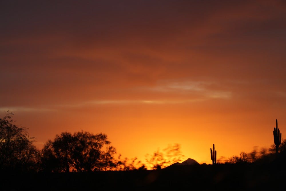 The sun sets in Mesa, Arizona on March 13, 2016.