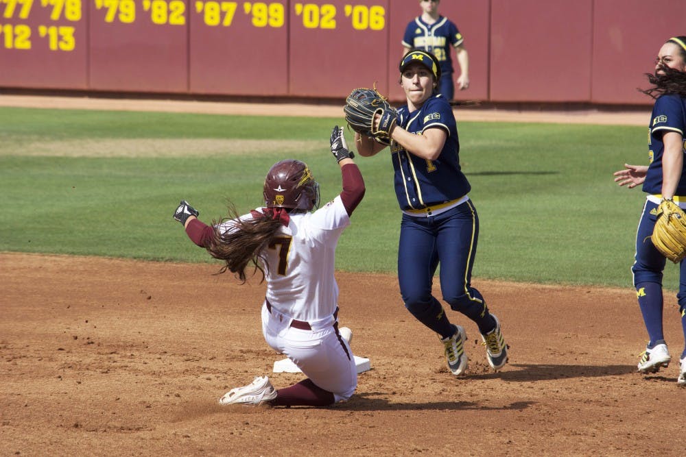 ASU senior Sierra Rodriguez attempts to take second base against Michigan sophomore Abby Ramirez, Sunday March 1, 2015, at Farrington Stadium in Tempe. The Sun Devils lost to the Wolverines 6-2. (Krista Tillman/The State Press)