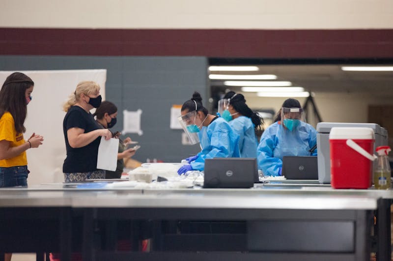 ASU students wait to get COVID tested in the SDFC Maroon Gym on the Tempe Campus, in Tempe, Arizona on Wednesday, August 26, 2020.
