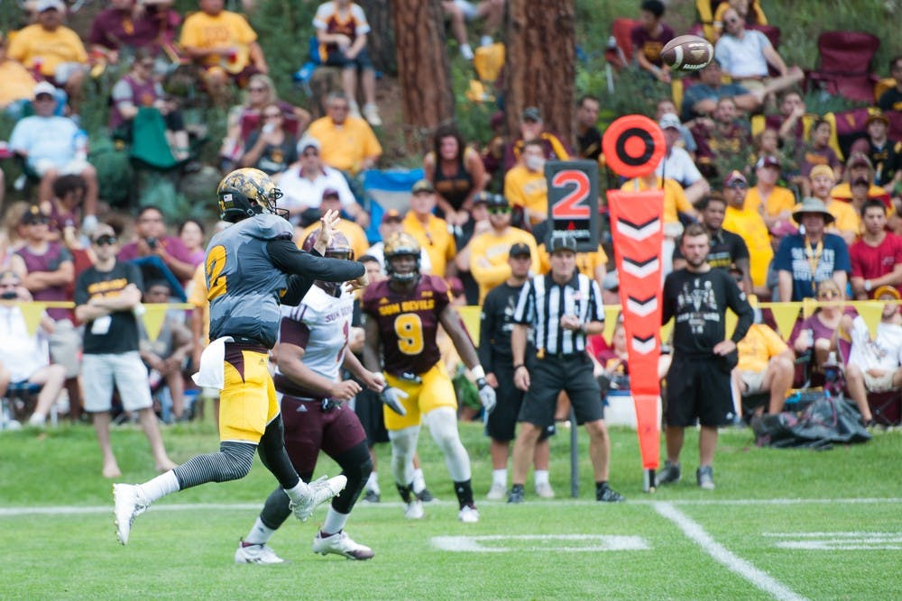 Redshirt senior quarterback Mike Bercovici throws a pass under pressure during the last day of Camp Tontozona on Saturday, Aug. 15, 2015, in Payson, Arizona.