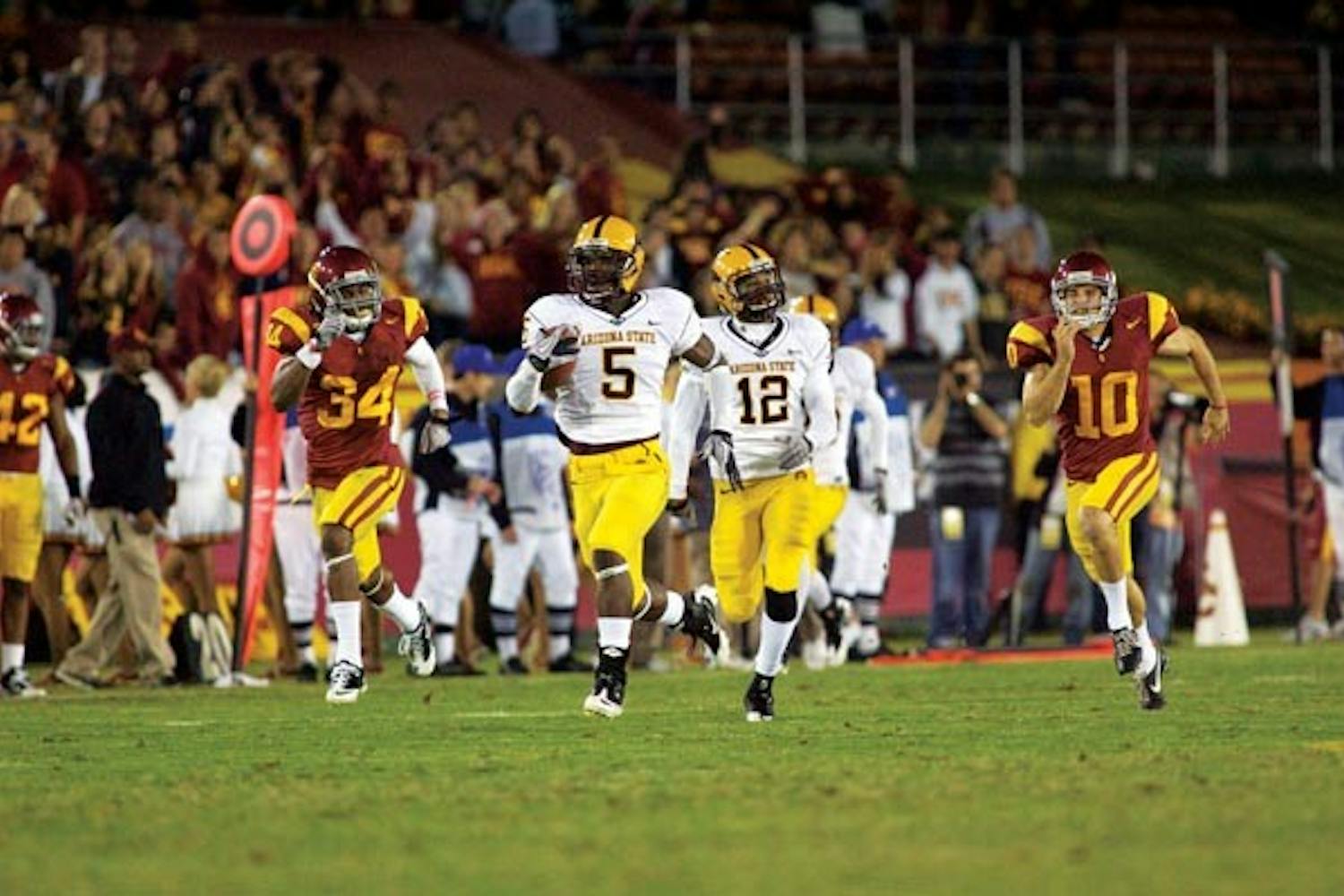 FUTILE CHASE: Senior cornerback LeQuan Lewis outruns USC defenders during last Sautrday's 34-33 ASU loss. Lewis returned a kickoff 100 yards for a touchdown just a week after making a key interception in ASU's win over Washington State. (Photo by Scott Stuk)