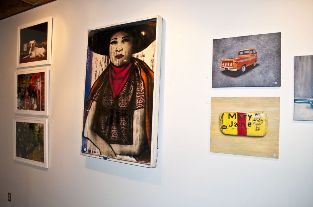 Work from local Arizona artists hang in the gallery space of the Hive. All different medias were present along with some of the makers of the work. (Photo by Katie Dunphy)